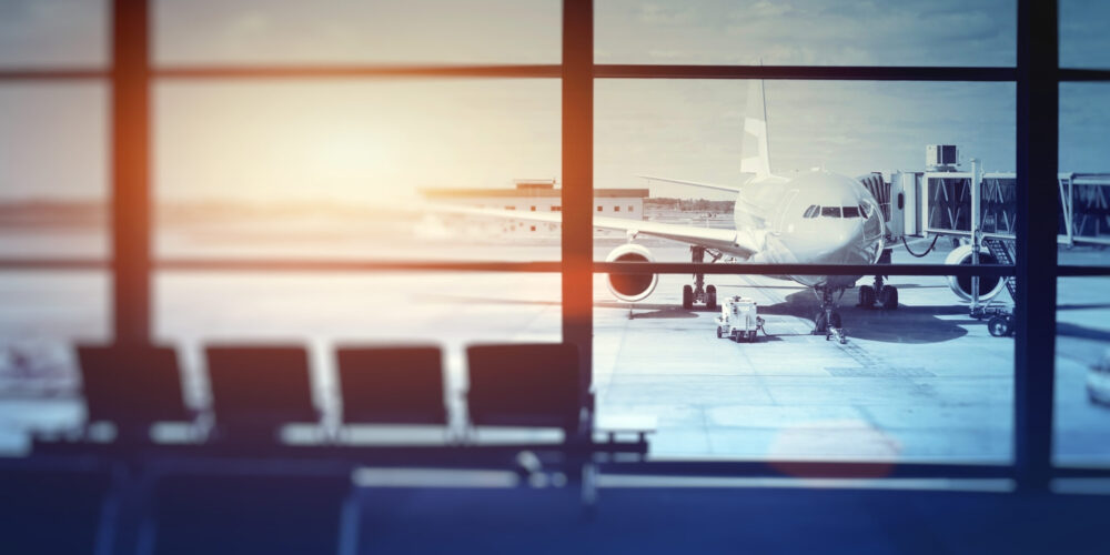 airplane waiting for departure in airport terminal, blurred horizontal background with place for text